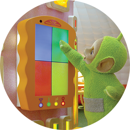 A light green character, with a round being face, is standing in front of a board with four colourful squares and pointing to it.