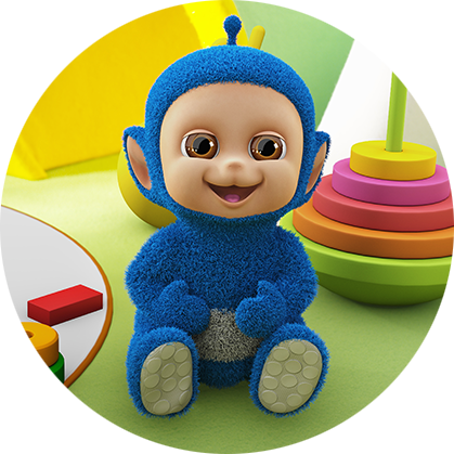 A happy blue character, with a round, beige face, is sitting on a green floor surrounded by colourful toys.