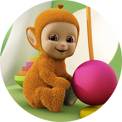 An orange character, with a roung, beige face, is sitting down on a green floor in front of a pink ball.