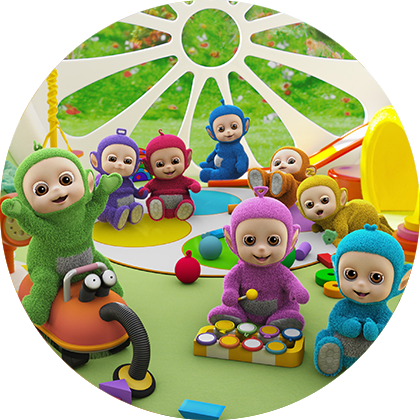 A bunch of cute characters, in various colours sitting on a green floor and playing with toys.
