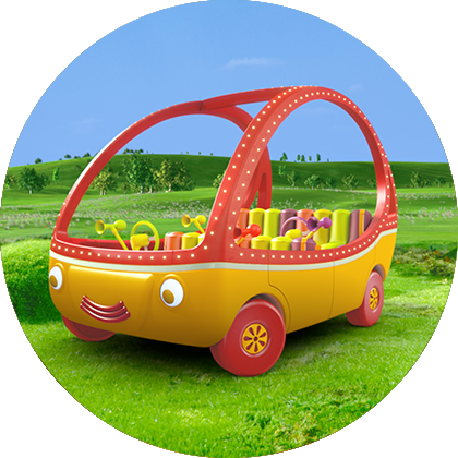 A uniquely shaped yellow car with eyes, red wheels and red hollow windows in the middle of a green field and a blue sky in the background.